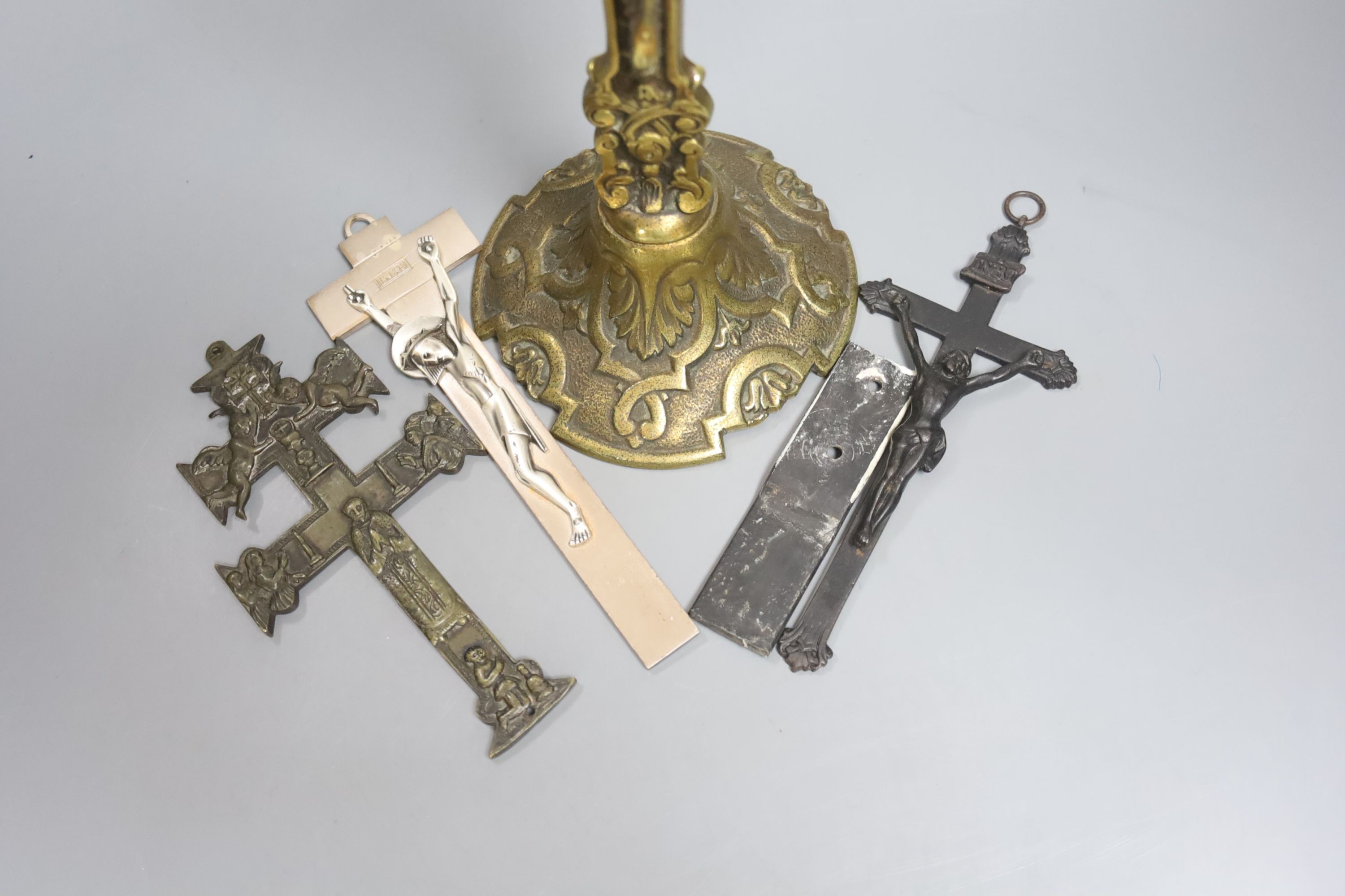 A group of four brass and metal crucifixes, largest 34cm